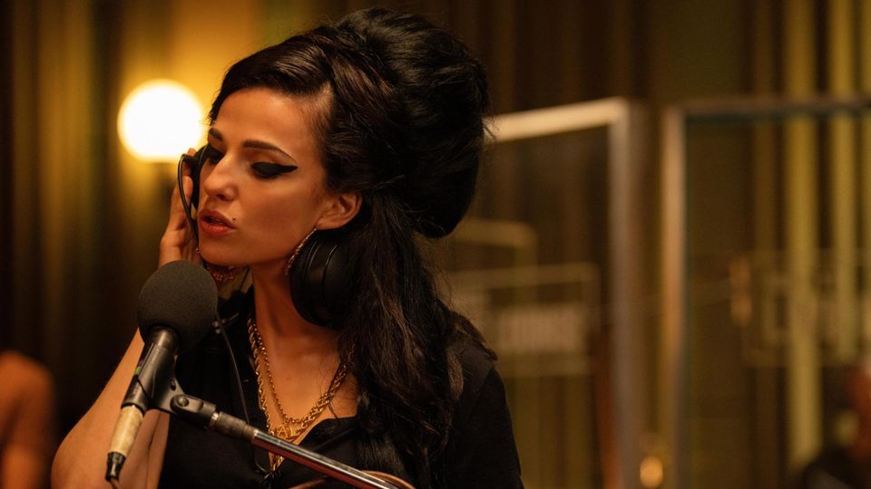 Marisa Abela als Amy Winehouse "Terug naar zwart" zingt in een microfoon