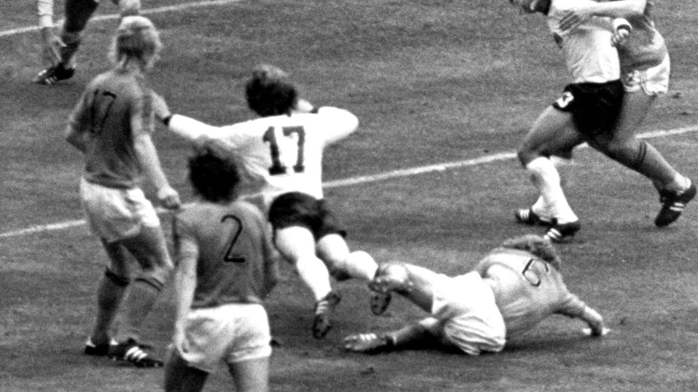 Eine Urszene des deutschen Fußballs. Hollands Wim Jansen (Nummer 6) versucht im WM-Finale 1974 mit gestrecktem Bein, das Dribbling von Bernd Hölzenbein zu unterbinden, doch das geht gründlich schief. Der geschickte Hölzenbein, der schon in der Zwischenrunde zwei Strafstöße herausgeholt hatte, nimmt die Einladung an und hakt ein wenig ein. Es gibt eine Berührung, Deutschland bekommt den Elfer und Paul Breitner verwandelt zum 1:1-Ausgleich. Es ist ein Strafstoß der Marke "selbst schuld". Doch für die Niederländer bedeutet die 1:2-Niederlage im Münchner Olympiastadion lange eine Schmach – und Hölzenbein wird bis in die Gegenwart gedrängt, doch endlich den Betrug zuzugeben.