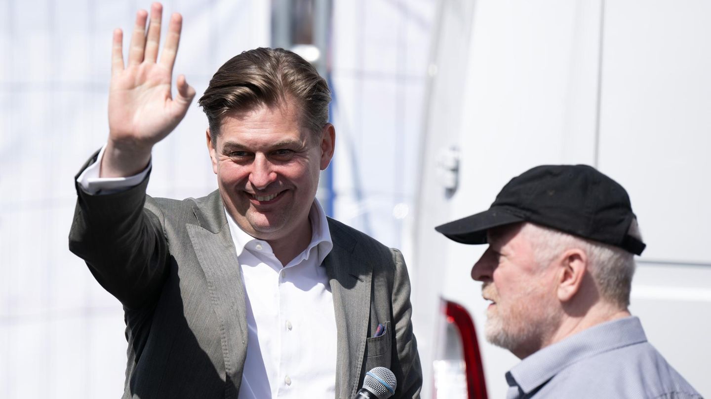 Maximilian Krah (l.), Spitzenkandidat der AfD für die Europawahl, winkt seinen Anhängern hinter der Bühne in Dresden zu