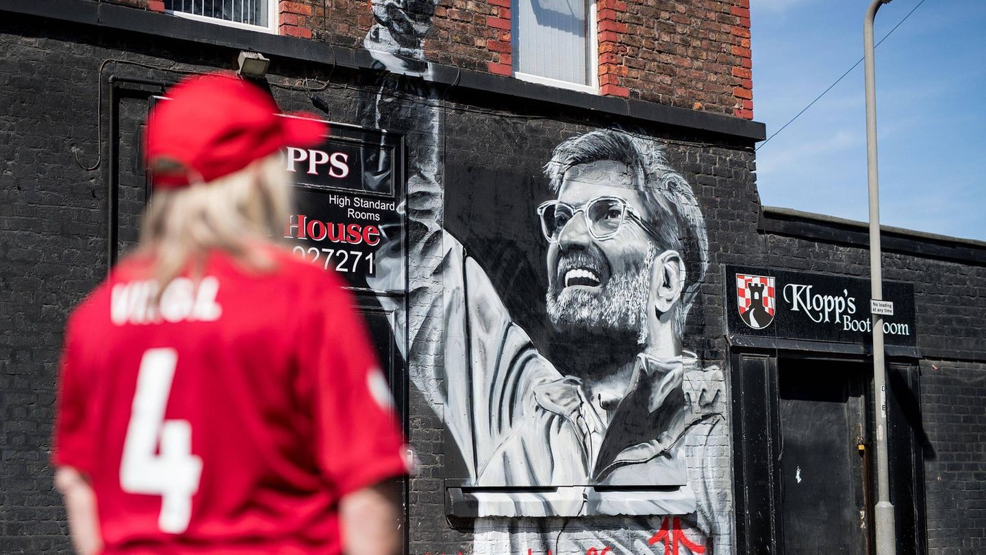 Abschied aus England: In der ganzen Stadt gibt es Streetart zu Ehren von Spielern und Trainern in der Geschichte des Liverpool FC. Doch niemand ist so präsent wie Jürgen Klopp. Alleine sechs Wandbilder sind dem Trainer gewidmet – so auch dieses an einem lokalen Geschäft, das nach dem Trainer benannt ist. Auch ein Pub in der Stadt trägt Klopps Namen. In der ganzen Stadt gibt es Streetart zu Ehren von Spielern und Trainern in der Geschichte des Liverpool FC. Doch niemand ist so präsent wie Jürgen Klopp. Alleine sechs Wandbilder sind dem Trainer gewidmet – so auch dieses an einem lokalen Geschäft, das nach dem Trainer benannt ist. Auch ein Pub in der Stadt trägt Klopps Namen.