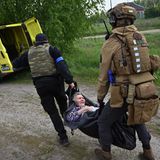 Die ukrainische Polizei evakuiert mit Hilfe von freiwilligen Sanitätern Walja, eine alte und gelähmte Ukrainerin