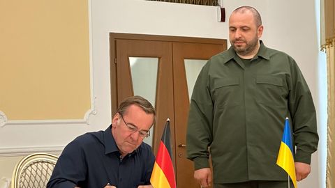 Boris Pistorius (SPD) trägt sich in Anwesenheit seines Amtskollegen Rustem Umjerow (r), aus der Ukraine, ins Gästebuch ein