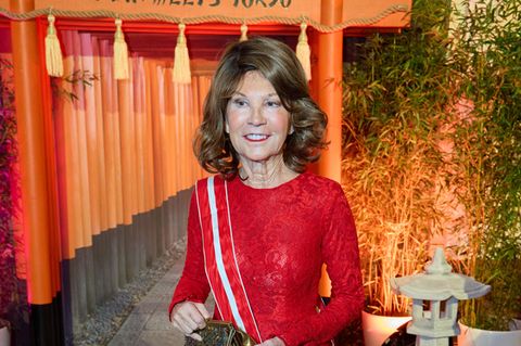 Brigitte Bierlein steht in rotem langen Kleid auf dem Juristenball 2024 in Wien, Österreich