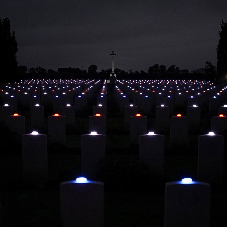 Kerzen werden auf jedem Grabstein des Commonwealth-Kriegsfriedhofs in der Normandie