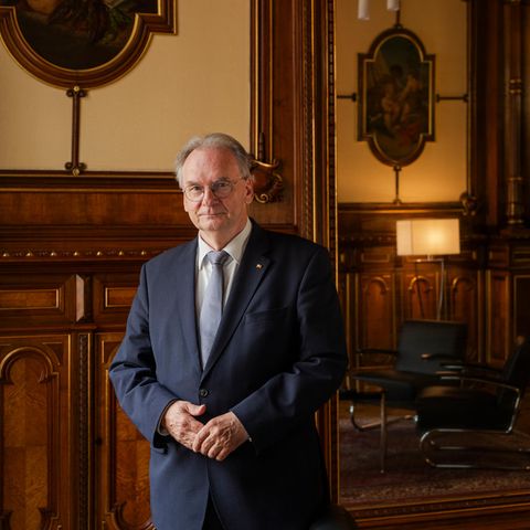 Germany's longest-serving Prime Minister: Reiner Haseloff stands in a suit in front of a wood-panelled wall