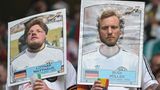 Deutsche Fans tragen Sammelkarten als Gesichtsverkleidung