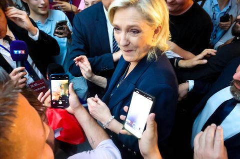 Marine Le Pen umringt von Journalisten
