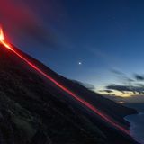 Ein Lavafluss reicht bis zum Meer.