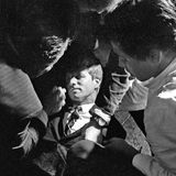 Mehrere Helfer beugen sich über Robert Kennedy