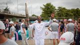 Rapper Snoop Dog trägt sichtlich stolz das Olympische Feuer