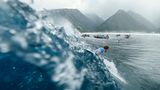 Magische Welle, magische Aussicht: John John Florence aus den Vereinigten Staaten surft auf die moosgrünen Berge der südpazifischen Insel zu.