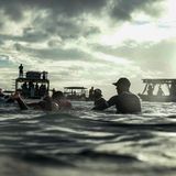 Strategiebeprechung auf dem Wasser, während Sonnenstrahlen durch die Wolken brechen. Carissa Moore (links) aus den Vereinigten Staaten spricht mit ihrem Trainer Shane Dorian während der ersten Runde im Surfen der Frauen.