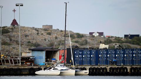 Ein Trimaran – ein Segelboot mit drei Rümpfen – ist in einer Ecke eines Hafens in Schweden festgemacht