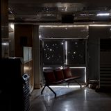 Licht fällt durch diverse Einschusslöcher in einem ansonsten dunklen Raum.