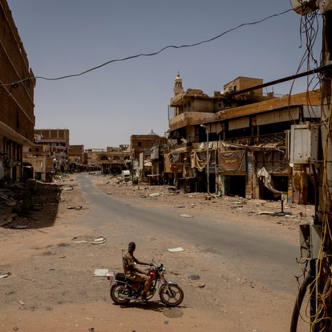 A lonely motorcycle in a completely destroyed street in Sudan