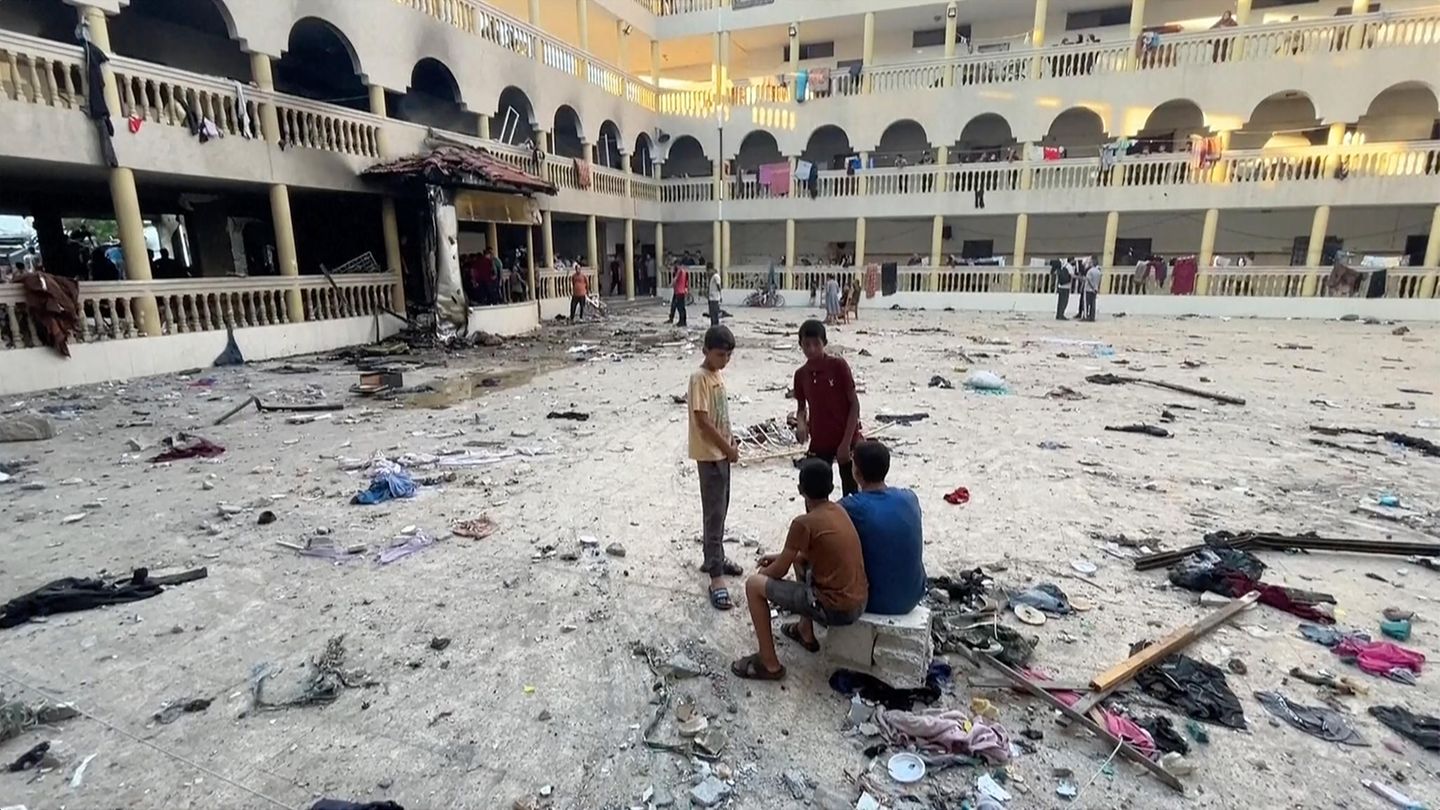 People sit at the Israeli Air Force in the Al-Tabain School in Gaza City