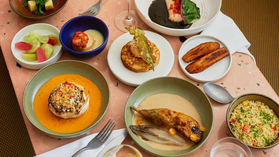 Vereinigtes Königreich: Eine Reihe von Gerichten aus der Speisekarte von "Chishuru", darunter Perlhuhn mit Yassa-Sauce und gegrilltem Hispi-Kohl mit Wassermelonensamen-Sauce Eine Reihe von Gerichten aus der Speisekarte von "Chishuru", darunter Perlhuhn mit Yassa-Sauce und gegrilltem Hispi-Kohl mit Wassermelonensamen-Sauce