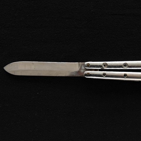 More and more knife crime: a butterfly knife on a black background