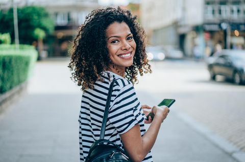 60 Euro Startguthaben mit Prepaid-Tarif von Vodafone: Junge Frau mit Smartphone in der Hand.