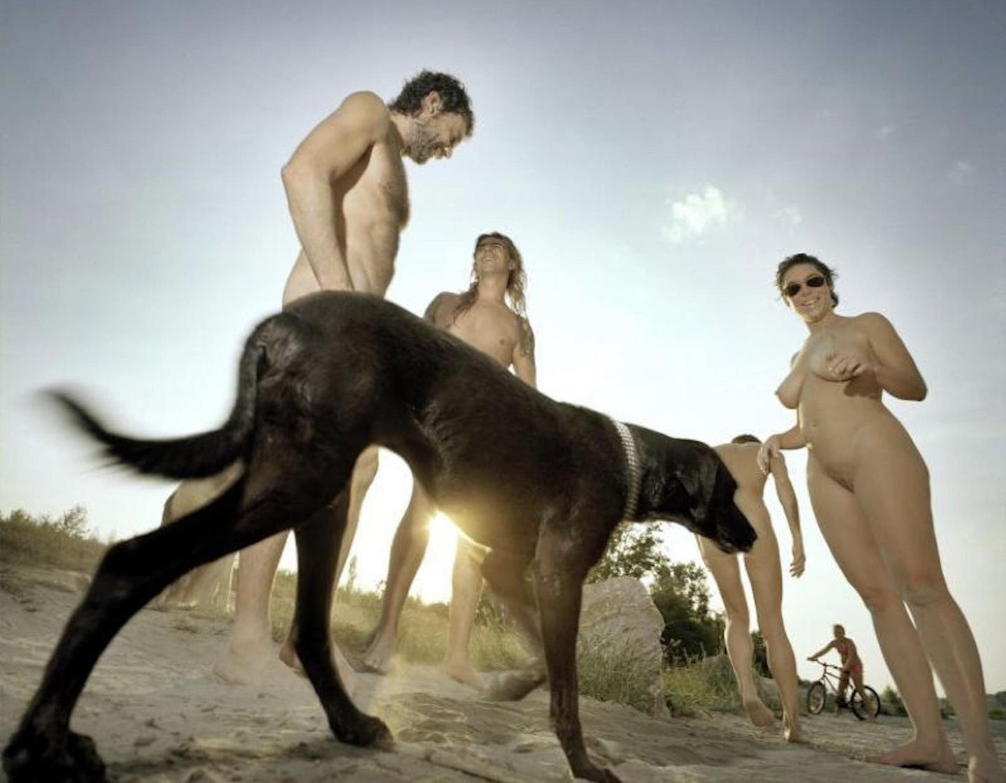 FKK-Badende mit Hund an einem Strand FKK-Badende mit Hund an einem Strand
