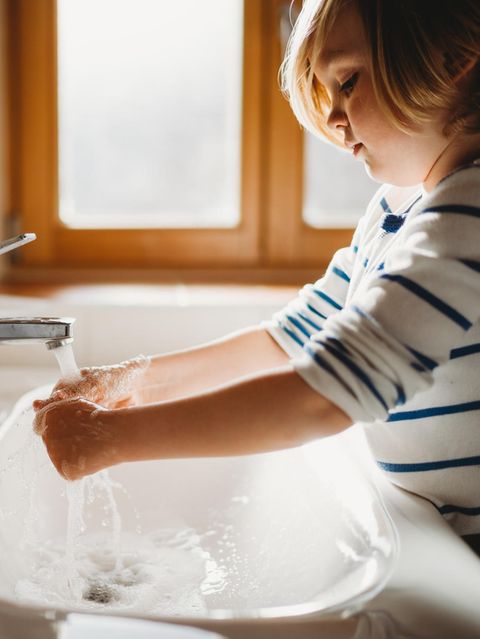Kleines Kind im Profil wäscht sich die Hände