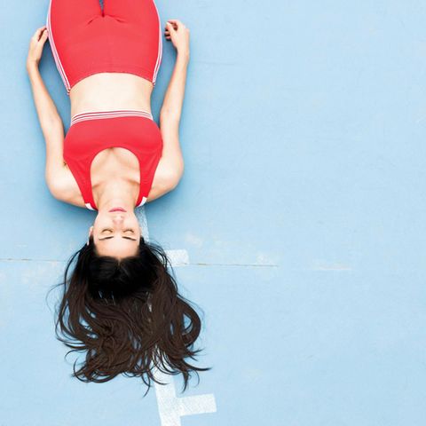 Sport makes you happier and happier. Here a woman lies on the floor after training