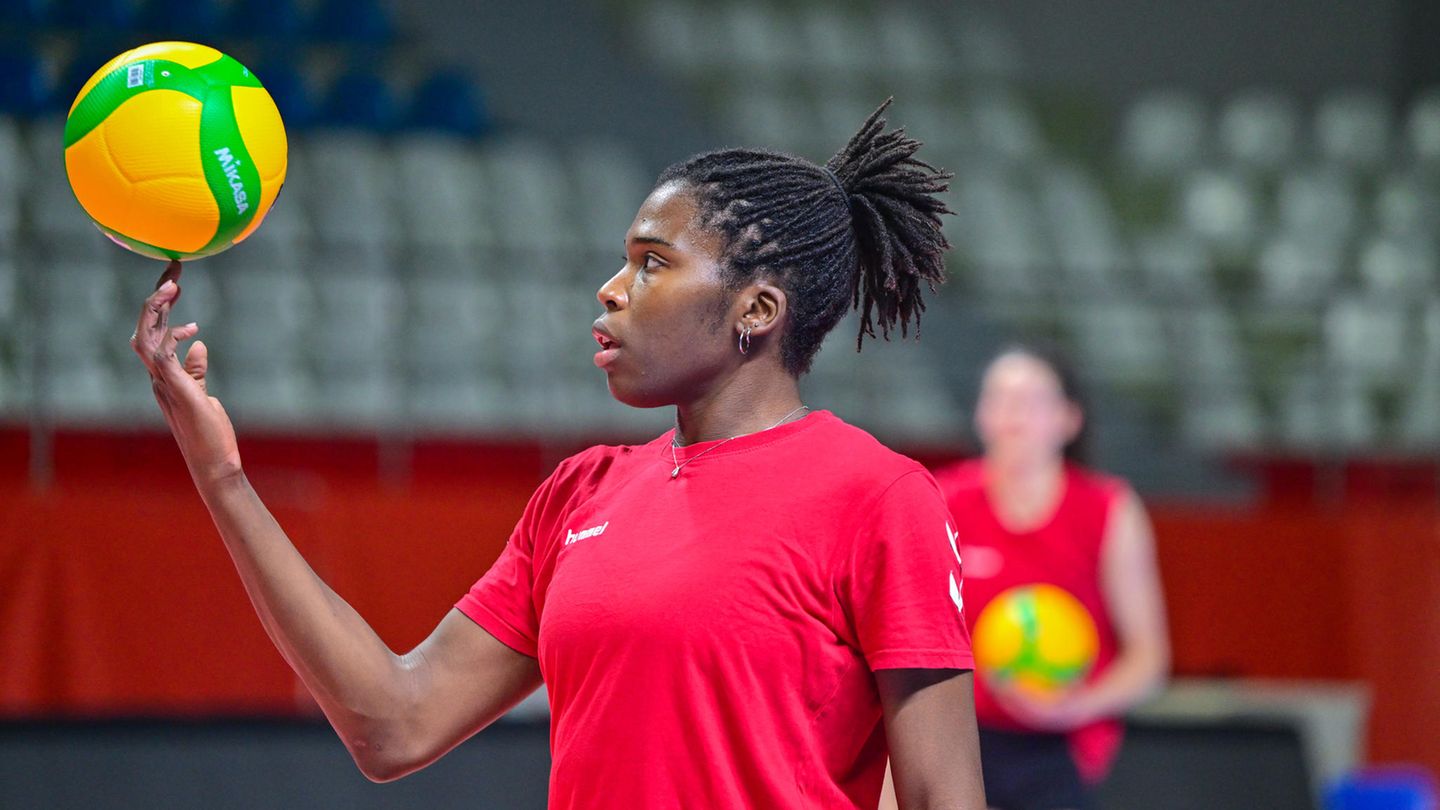 Krystal Rivers balances a volleyball on her finger