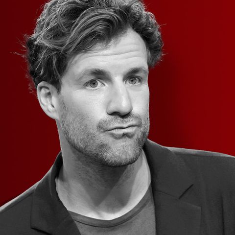 Luke Mockridge Portrait in Schwarz Weiß auf rotem Grund