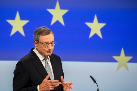 Mario Draghi steht an einem Rednerpult vor EU-Sternen