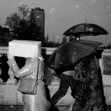 Menschen laufen bei Regen über die O'Connell Bridge