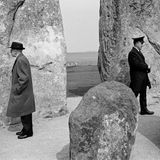 Zwei Männer mit Mantel und Hut bei den Steinfiguren von Stonehedge