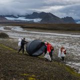 Nachhaltigkeit: Helfer halten auf Spitzbergen eine schwarze Plastik-Tonne fest