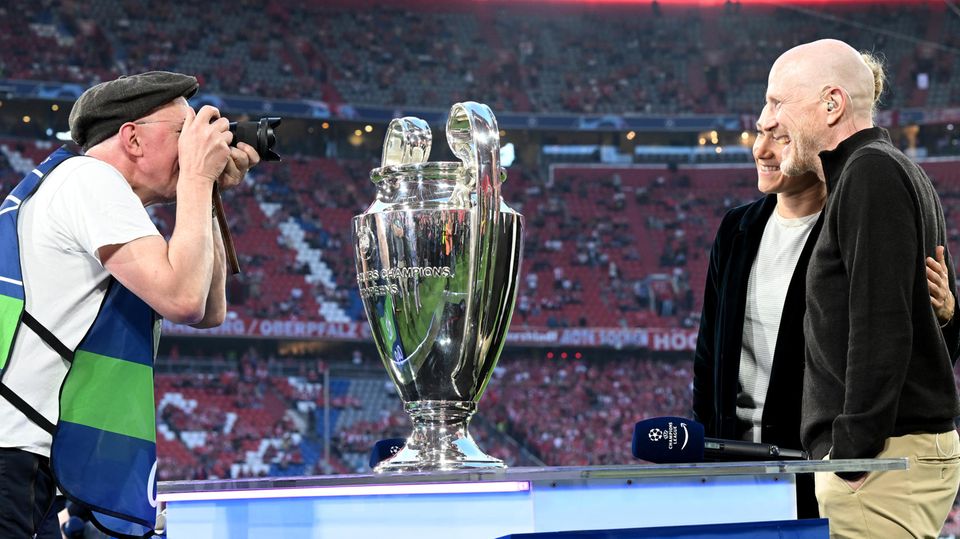 Ein Fotograf fotografiert TV-Experte Matthias Sammer (r.) hinter der Champions-League-Trophäe