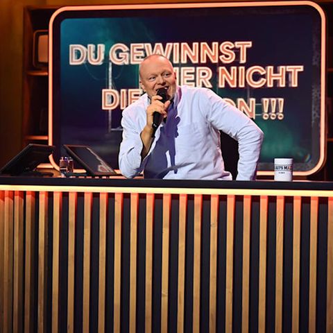 Der Moderator Stefan Raab sitzt am Pult seiner neuen Show beim Streaminganbieter RTL Plus, er trägt ein blaues Hemd