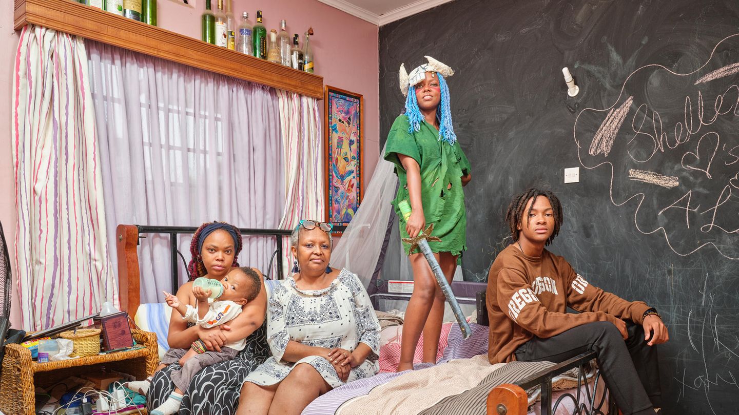 Cosplayerin Arianne posiert in ihrem Cosplay Outfit mit ihrer familie in ihrem Schlafzimmer