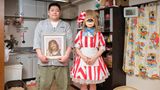 Cosplayerin Monaka posiert mit ihrem Bruder der ein Foto der verstorbenen Mutter in der Hand hält in ihrem Kostüm in der Küche