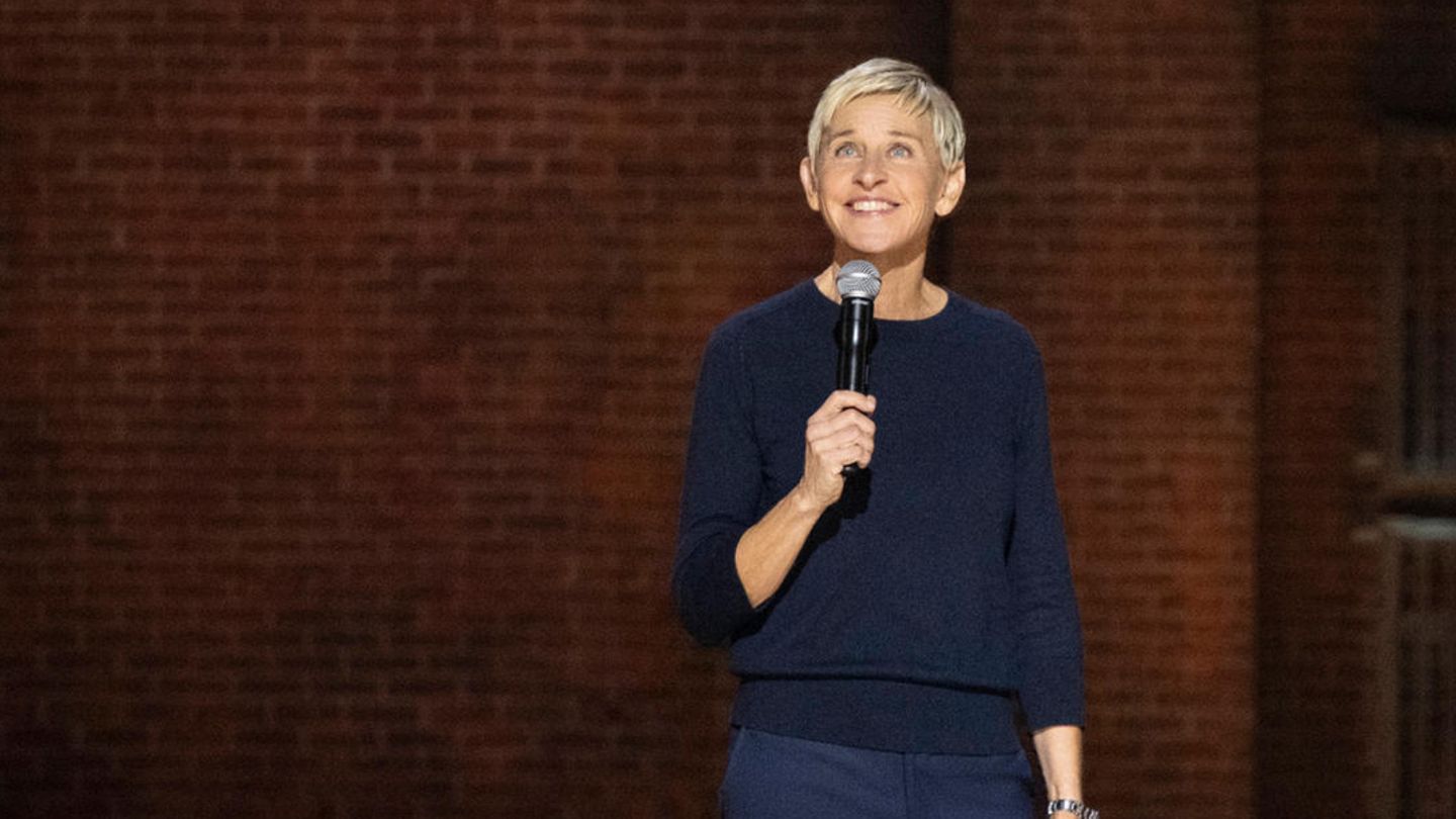 Ellen DeGeneres steht auf einer Bühne und hält ein Mikrophon in der Hand