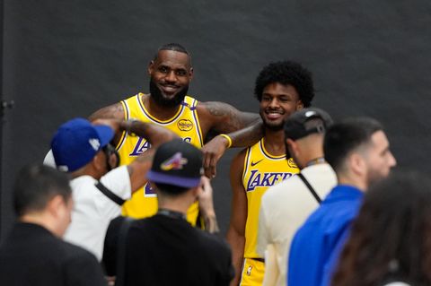 LeBron James und sein Sohn Bronny lächeln im gelben Lakers-Trikot für die Fotografen