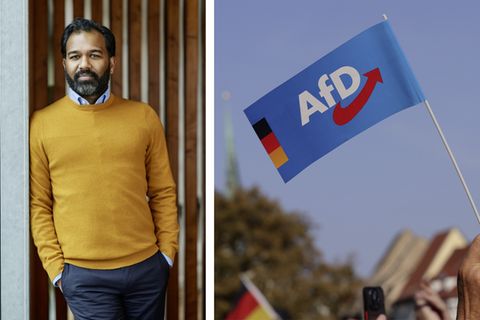 Kolumnist Anpalagan neben einer AfD Flagge