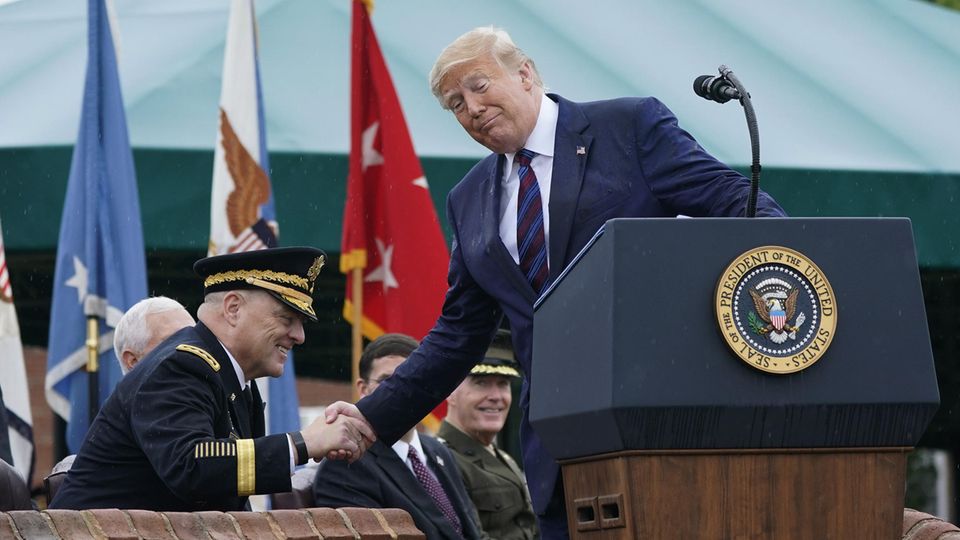 Donald Trump and Mark Milley shake hands