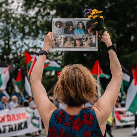 Karoline Preisler holds a sign with faces on a pro-Palestine demo