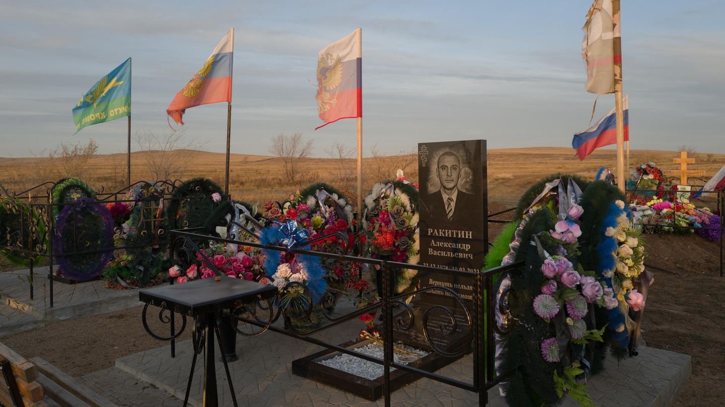 Russische Flaggen wehen über den Gräbern der Soldaten aus Sabaikalsk, die an der Front in der Ukraine ums Leben kamen. Dabei ist die mehr als 6600 Kilometer entfernt. Über den Toten Alexander Nikitin, dessen Grabstein auf dem Foto zu sehen ist, hieß es in einem Fernsehbeitrag: "Normale Menschen werden Helden"  