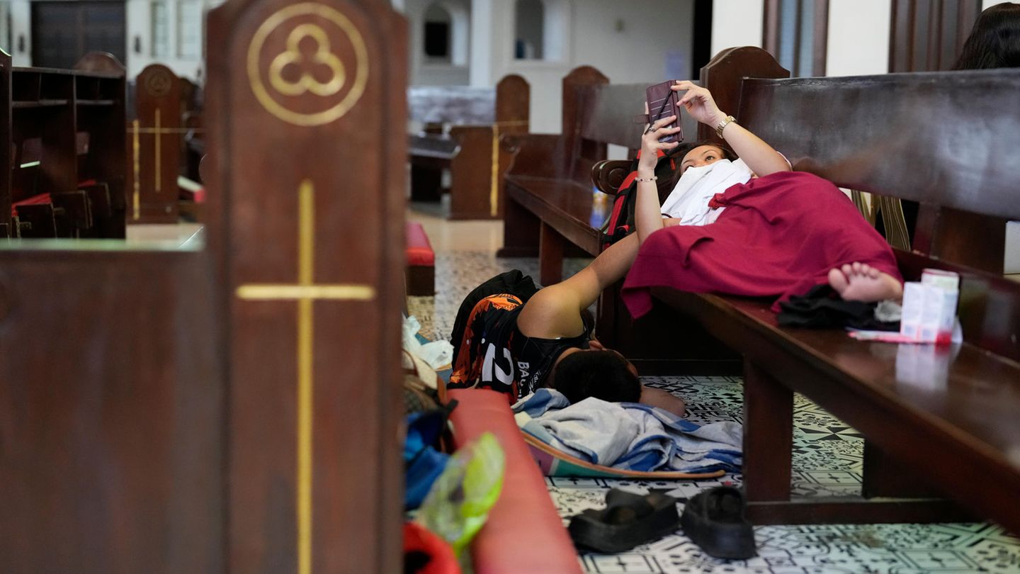 Evakuierte liegen auf Bänken in der Pfarrei Holy Family, die als vorübergehendes Evakuierungszentrum für Quezon genutzt wird. "Innerhalb von 24 Stunden ist so viel Regen gefallen wie sonst in zwei Monaten", sagte Glenda Ong Bongao, Gouverneurin von Albay, einem Radiosender in Manila