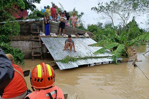 Rettungskräfte setzen wie hier in Libon, Provinz Albay, Boote ein, um noch auf Dächern festsitzende Bewohner zu erreichen