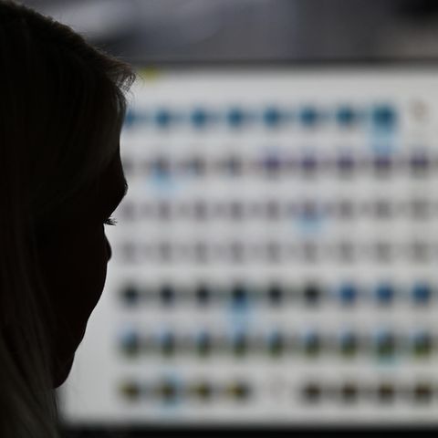 Eine Frau betrachtet auf einem Computermonitor Fotos von Missbrauchsopfern