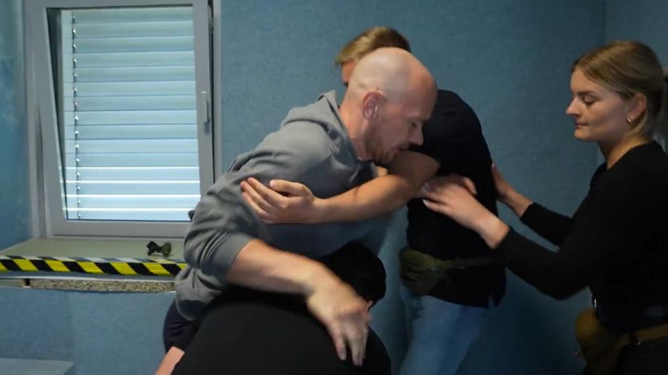 Young police officers practice how to gain control of a passenger who is resisting strongly