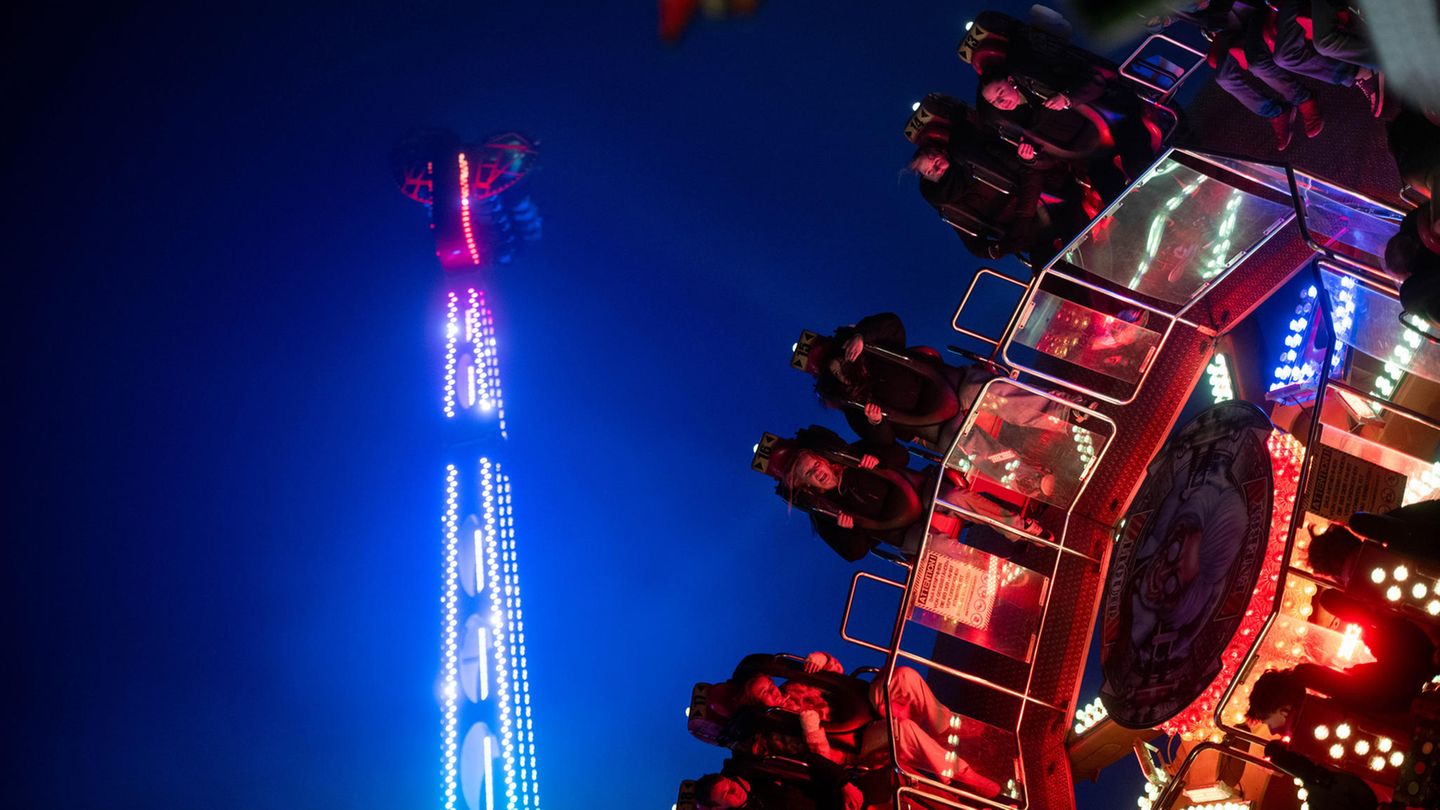 Beleuchtete Fahrgeschäfte auf der Allerheiligenkirmes in Soest bei Dunkelheit