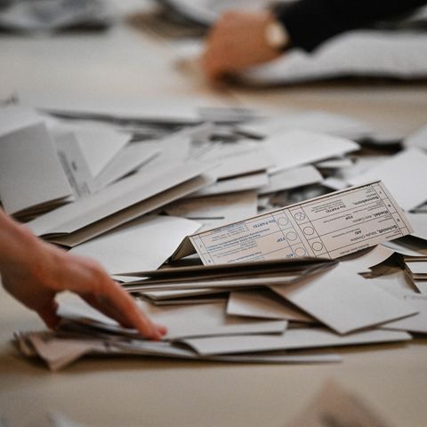 Many ballot papers are in a polling station during a new election