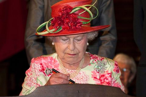 Queen Elizabeth II. schreibt in ein Buch
