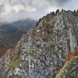 In den Fels gehauener Weg Sentiero delle Meatte in fahlem Licht mit Wolken